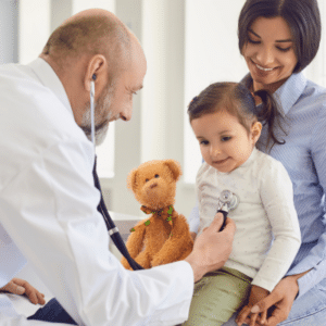 Pediatrician checking child with stethoscope for well-child visits