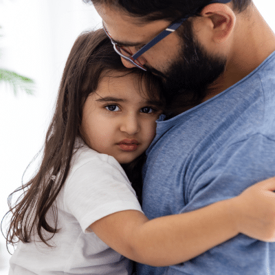 A man holding a child, representing anxiety in kids